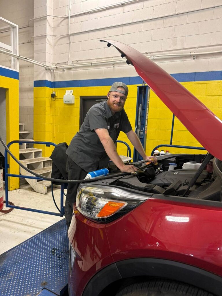Technician working under the hood of an SUV at Panhandle Diesel and Automotive in Scottsbluff